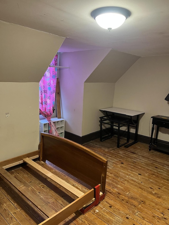 staircase featuring hardwood / wood-style flooring and vaulted ceiling