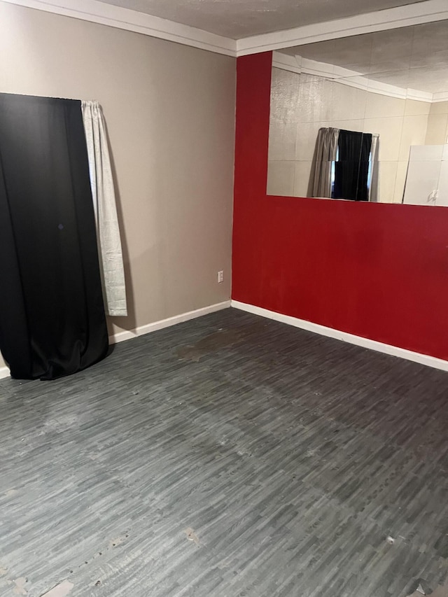 empty room with crown molding and dark hardwood / wood-style floors