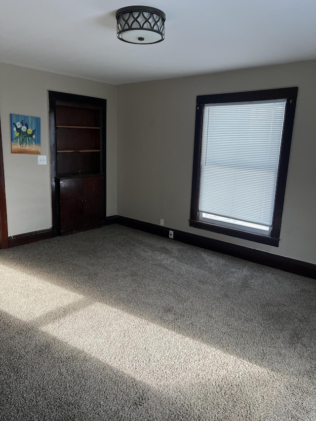 unfurnished room featuring carpet flooring