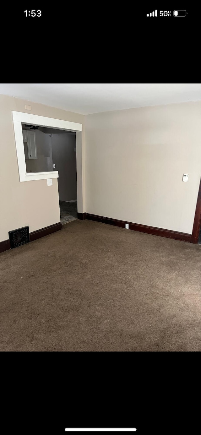 unfurnished room with baseboards, visible vents, and carpet flooring