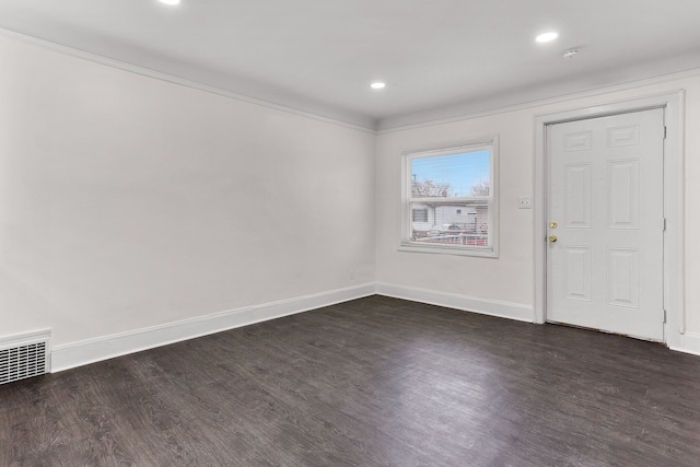 entrance foyer with ornamental molding and dark wood-type flooring