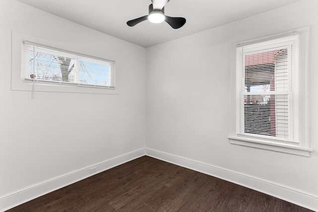 unfurnished room with ceiling fan, dark wood-type flooring, and a wealth of natural light