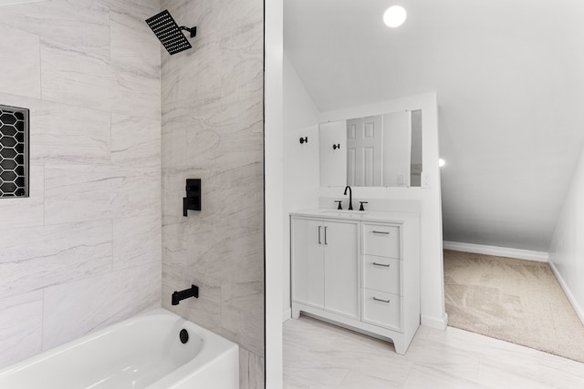 bathroom featuring vanity and tiled shower / bath