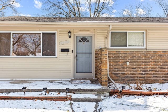 view of snow covered property entrance