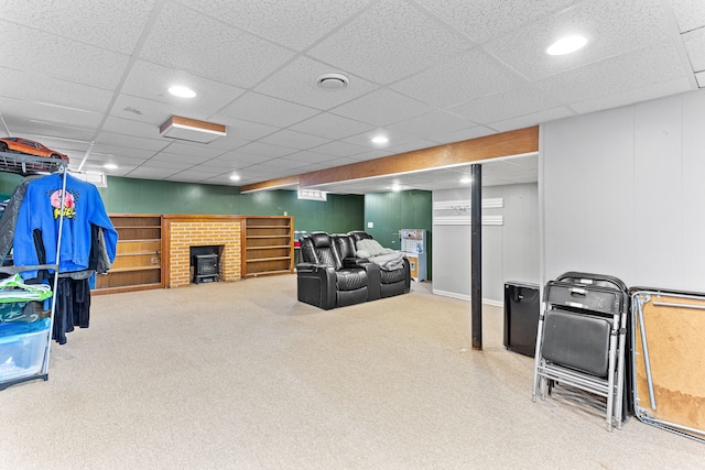 carpeted living room featuring a paneled ceiling