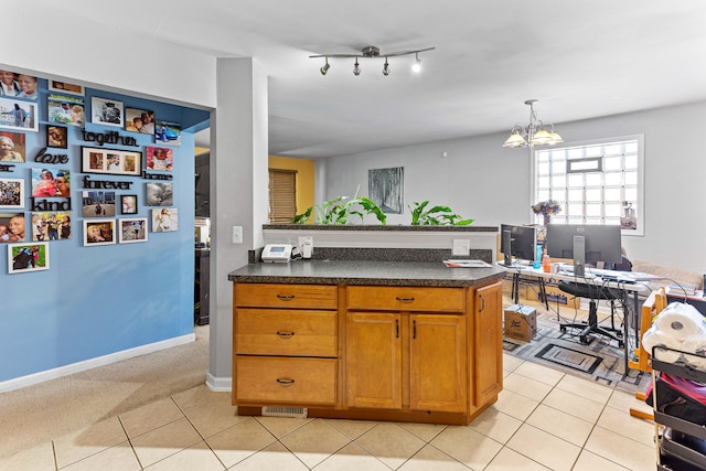 kitchen featuring an inviting chandelier, light colored carpet, and decorative light fixtures