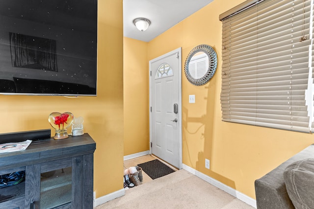 view of carpeted foyer entrance