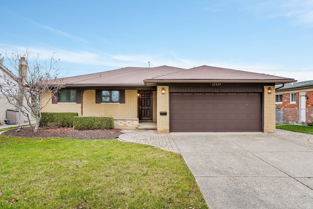 view of front of house featuring a garage and a front lawn