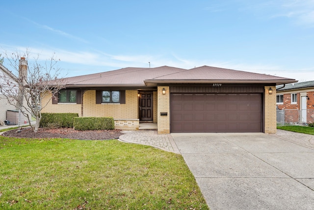 view of front of house featuring a garage and a front lawn