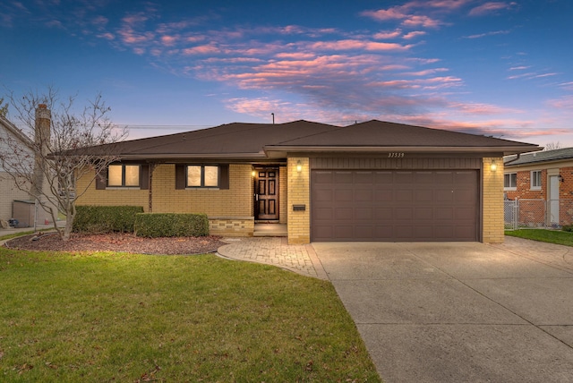 view of front facade featuring a lawn and a garage