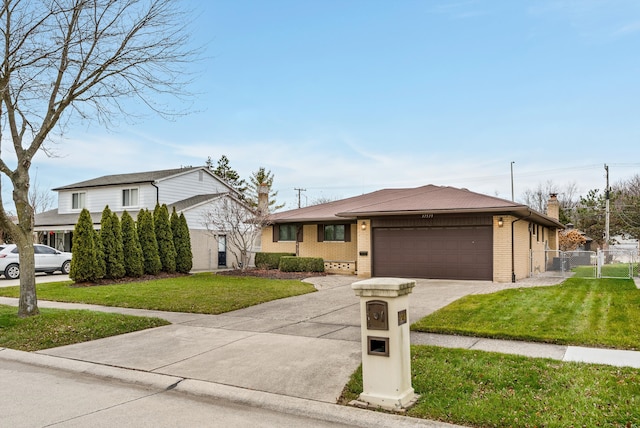 view of front of property with a front yard and a garage