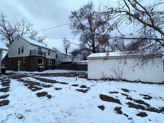 snowy yard with a balcony