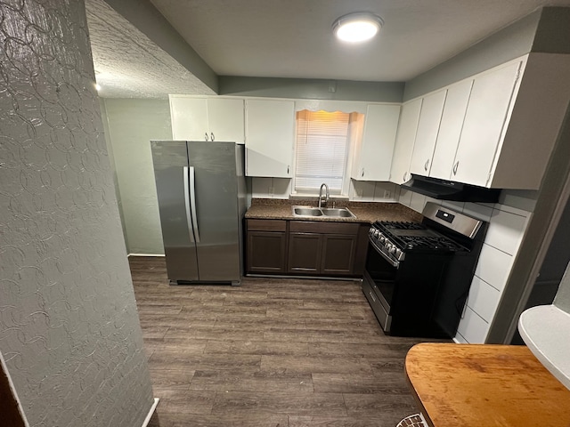 kitchen with sink, stainless steel appliances, ventilation hood, white cabinets, and hardwood / wood-style flooring