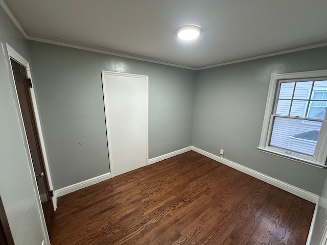 spare room with dark hardwood / wood-style floors and ornamental molding