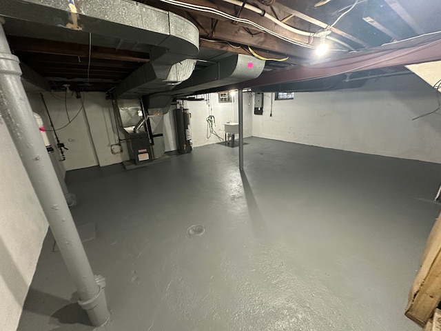 basement featuring heating unit and water heater