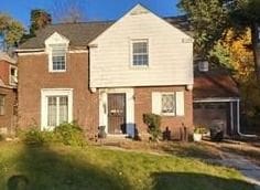 rear view of house with a lawn