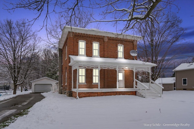 italianate home featuring a porch, a garage, and an outdoor structure