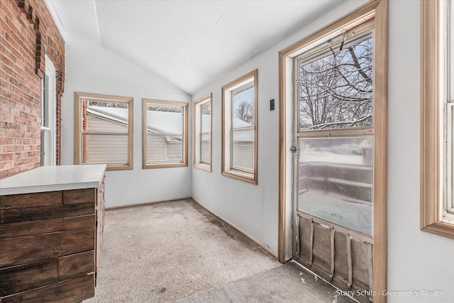 unfurnished sunroom featuring lofted ceiling