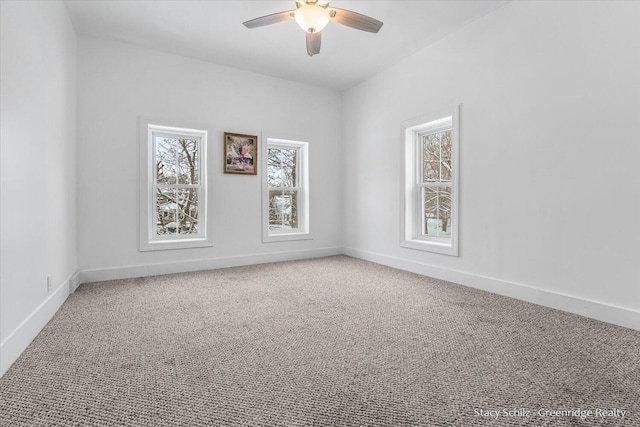 carpeted spare room with ceiling fan