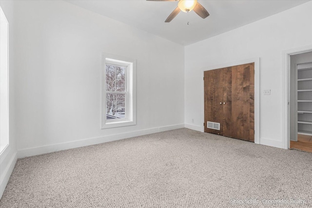 unfurnished bedroom with ceiling fan and carpet floors