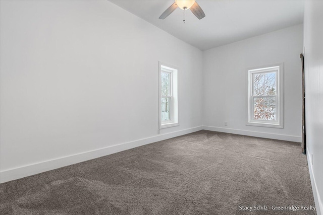 carpeted spare room featuring ceiling fan