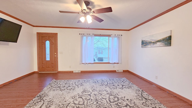 entryway with wood-type flooring, ceiling fan, and ornamental molding