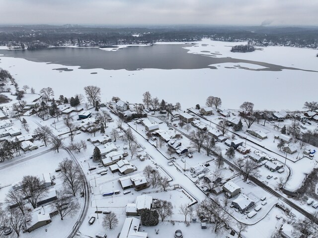 snowy aerial view with a water view