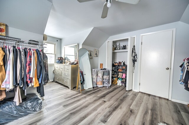 bedroom featuring ceiling fan, light hardwood / wood-style flooring, and vaulted ceiling