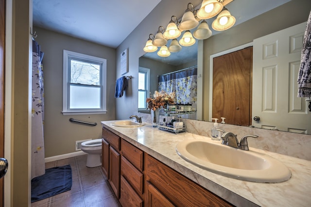 bathroom featuring tile patterned floors, vanity, and toilet