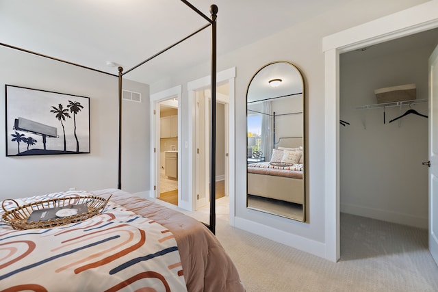 bedroom with a closet and light colored carpet