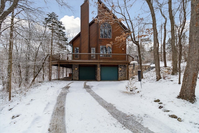 view of front of property featuring a garage and a deck