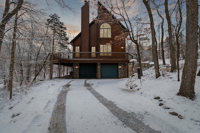 view of front of home featuring a garage and a deck