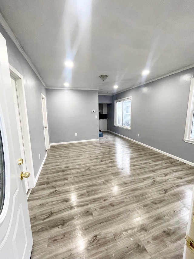 interior space featuring wood-type flooring and ornamental molding