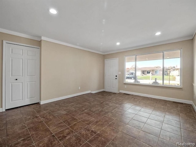 unfurnished room with crown molding