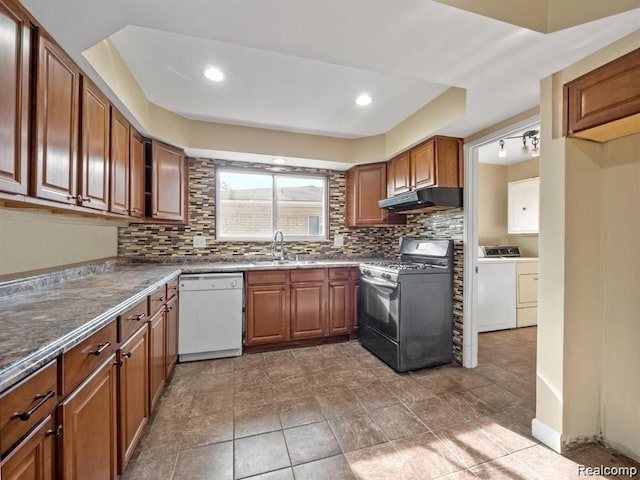 kitchen featuring decorative backsplash, gas range, sink, separate washer and dryer, and dishwasher