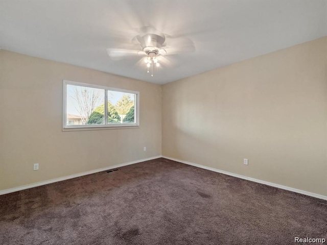 carpeted spare room featuring ceiling fan