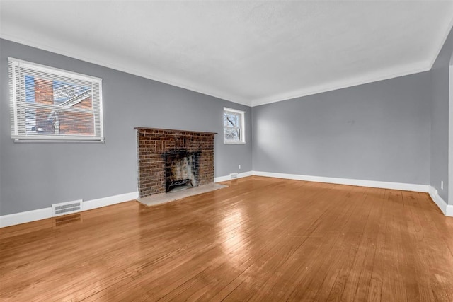 unfurnished living room with a fireplace, light hardwood / wood-style floors, and ornamental molding