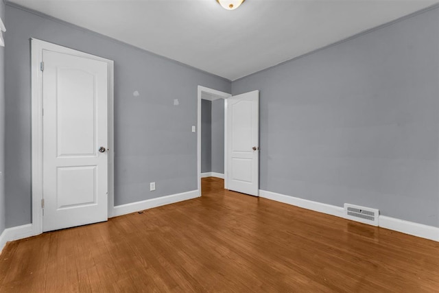 unfurnished bedroom with hardwood / wood-style floors