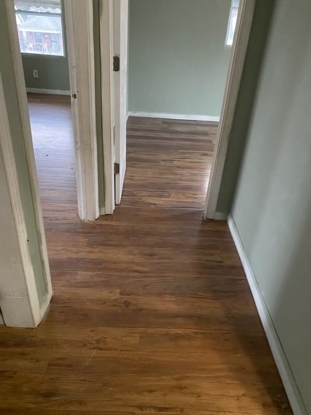 corridor with dark wood-type flooring