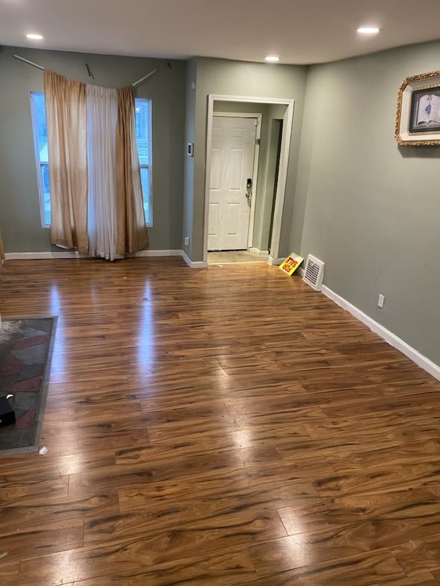 unfurnished room with dark hardwood / wood-style floors