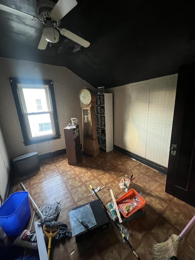 interior space with parquet floors, vaulted ceiling, and ceiling fan