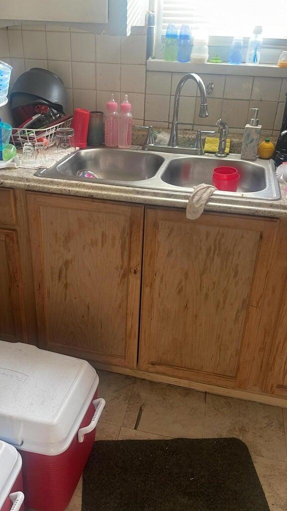 kitchen featuring tasteful backsplash, tile patterned floors, and sink