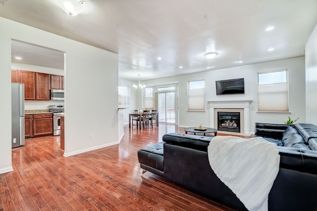 living room featuring dark wood-type flooring and an inviting chandelier