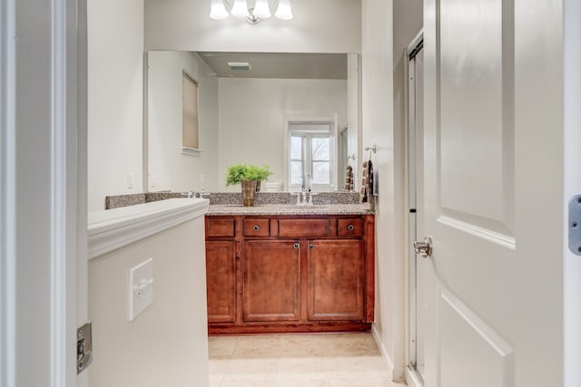 bathroom with tile patterned flooring and vanity