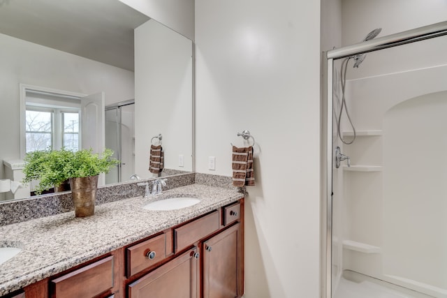 bathroom featuring vanity and a shower with shower door