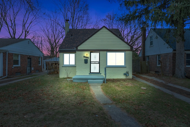 bungalow-style house featuring a lawn