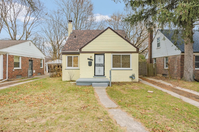 bungalow-style home featuring a front lawn