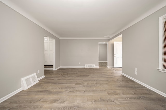 unfurnished room with wood-type flooring