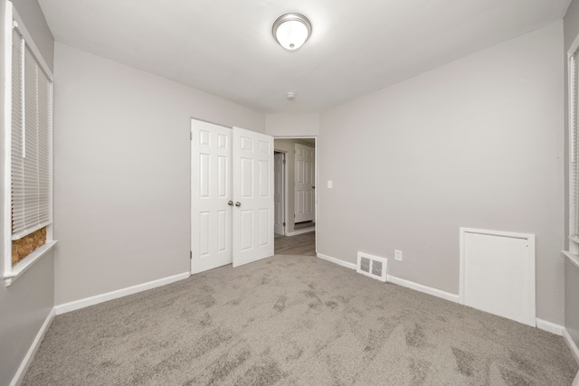 unfurnished bedroom with carpet floors