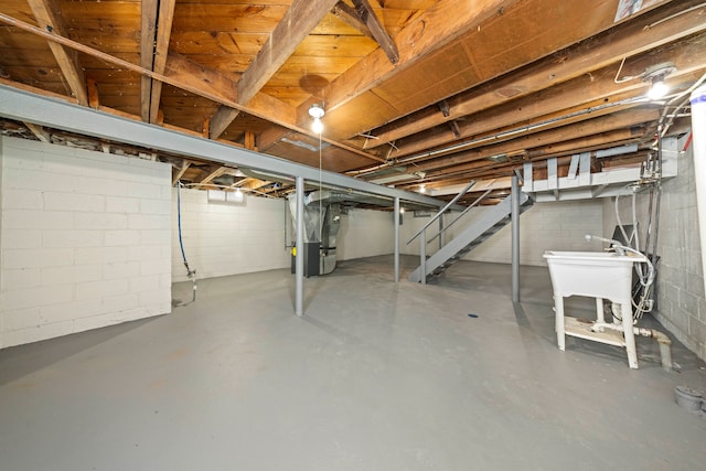 basement with heating unit and sink